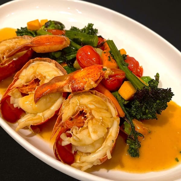 LouCas's lobster tails with broccolini, cherry tomatoes, and butternut squash in a rich sauce.